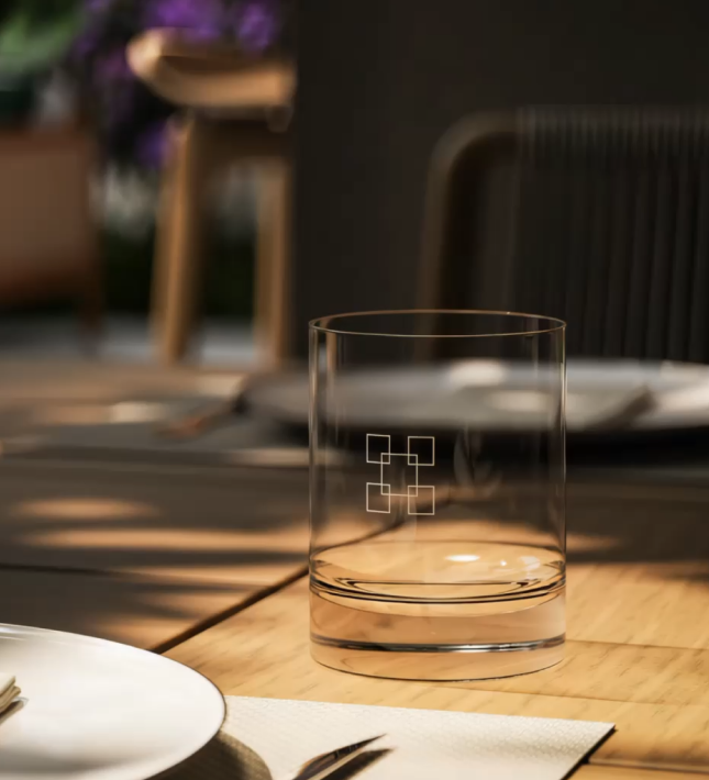 Etched crystal glass on a sunlit dining table